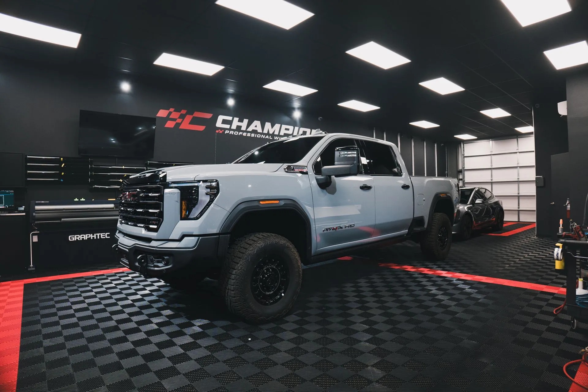 Silver Chevrolet truck photographed in the Champion Window Tinting workshop